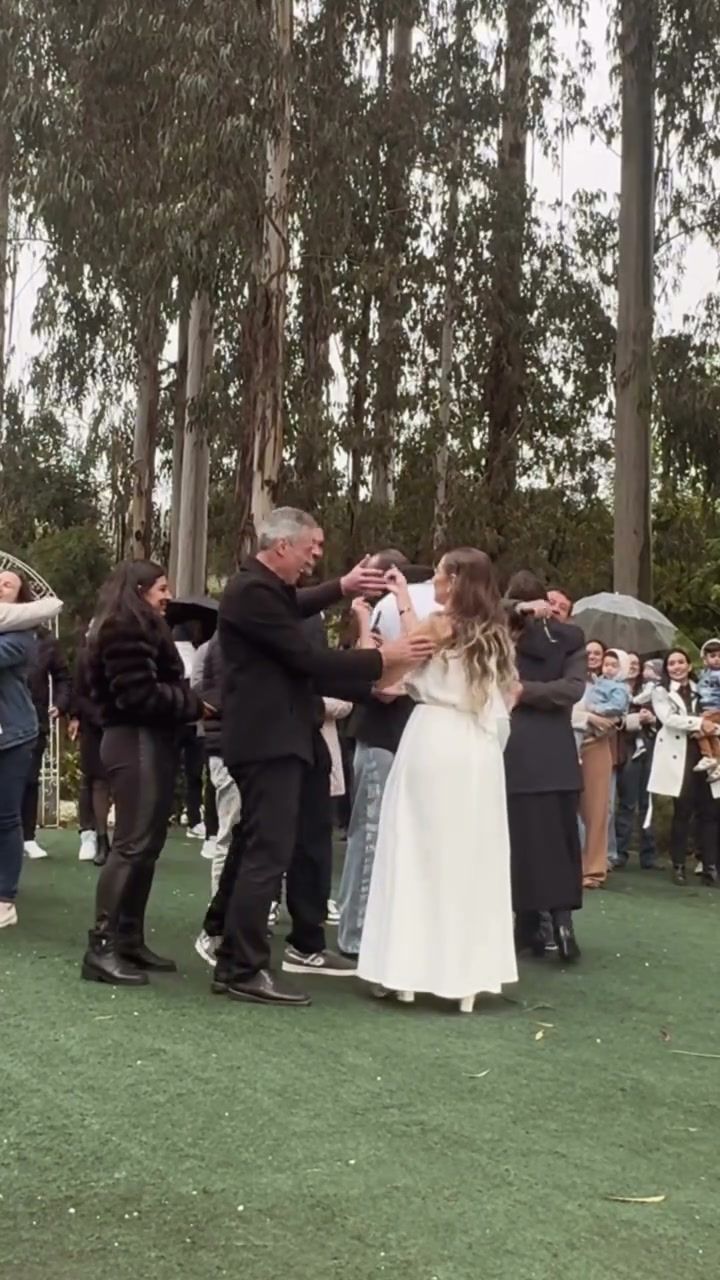 Convidados celebrando no gramado em frente ao bosque